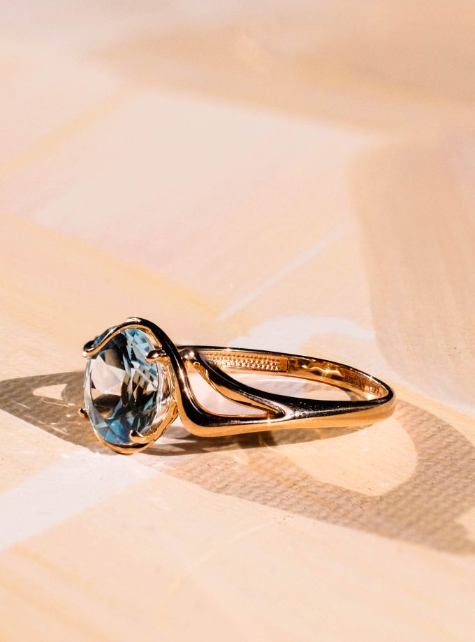 Rausvo aukso žiedas su žydrojo topazo brangakmeniu
